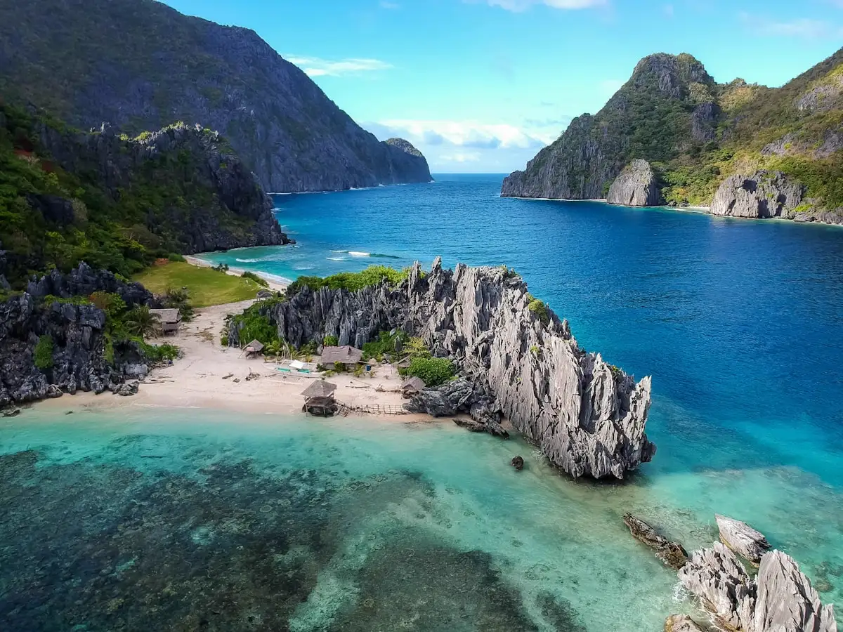 Limestone cliffs, a beach and turquoise sea in the Philippines